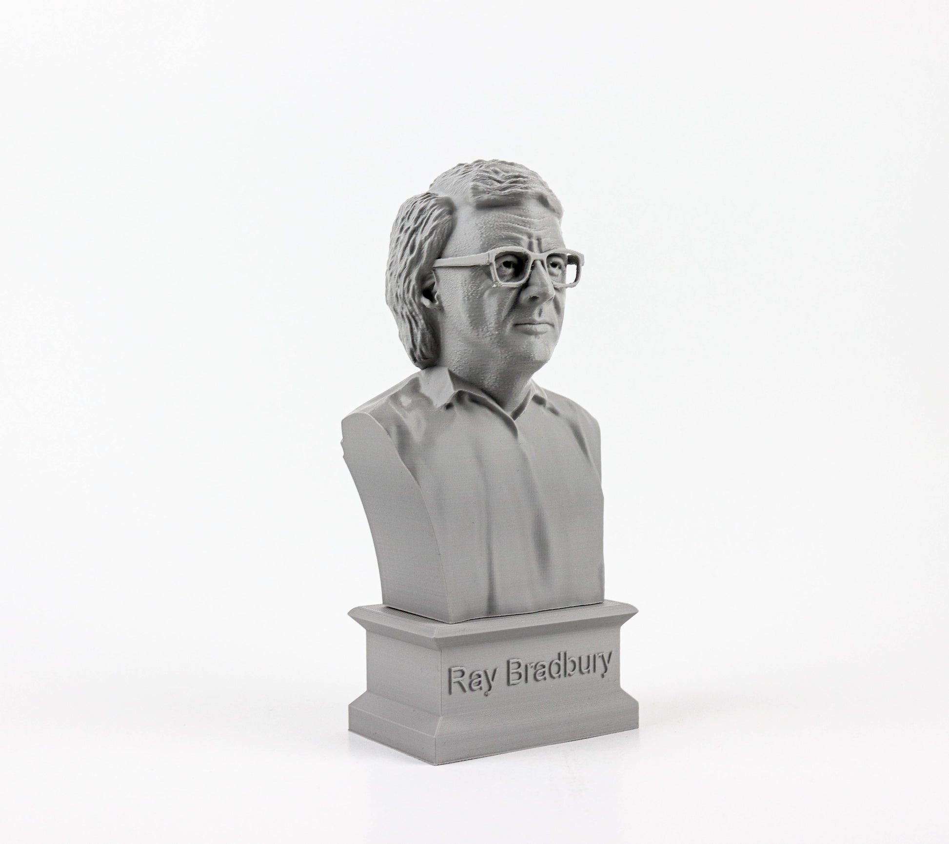 A gray bust of a man wearing glasses, with the name "Ray Bradbury" engraved on the base.