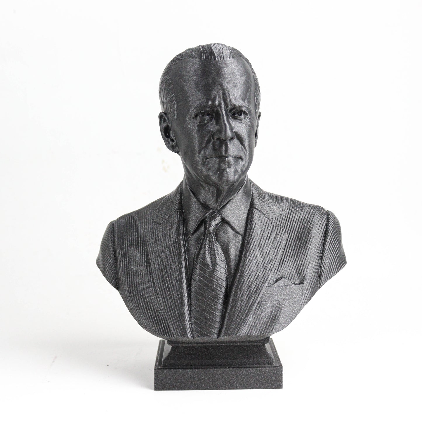 A black and white bust sculpture of a man wearing a suit and tie.