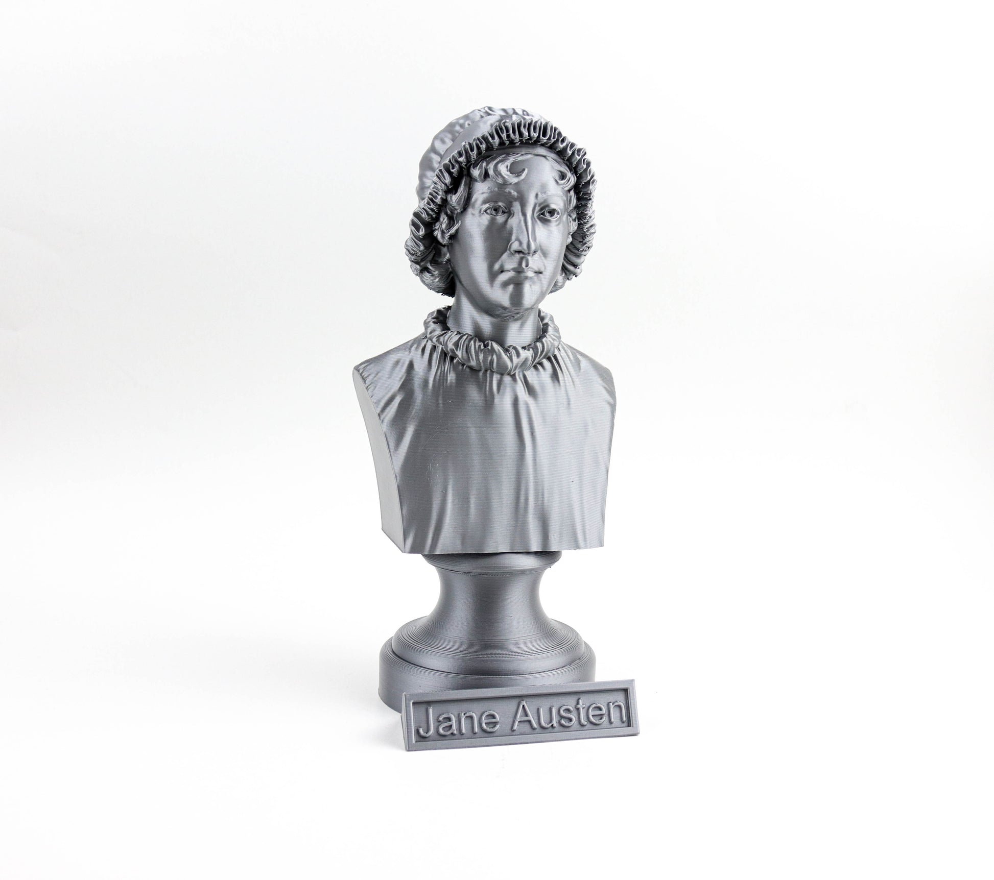 A silver bust of a woman, likely representing Jane Austen, is displayed on a pedestal with the name "Jane Austen" inscribed below it.