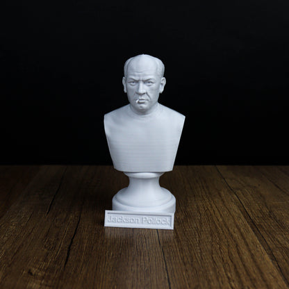 A white bust of a man is displayed on a wooden surface, with a nameplate below it.