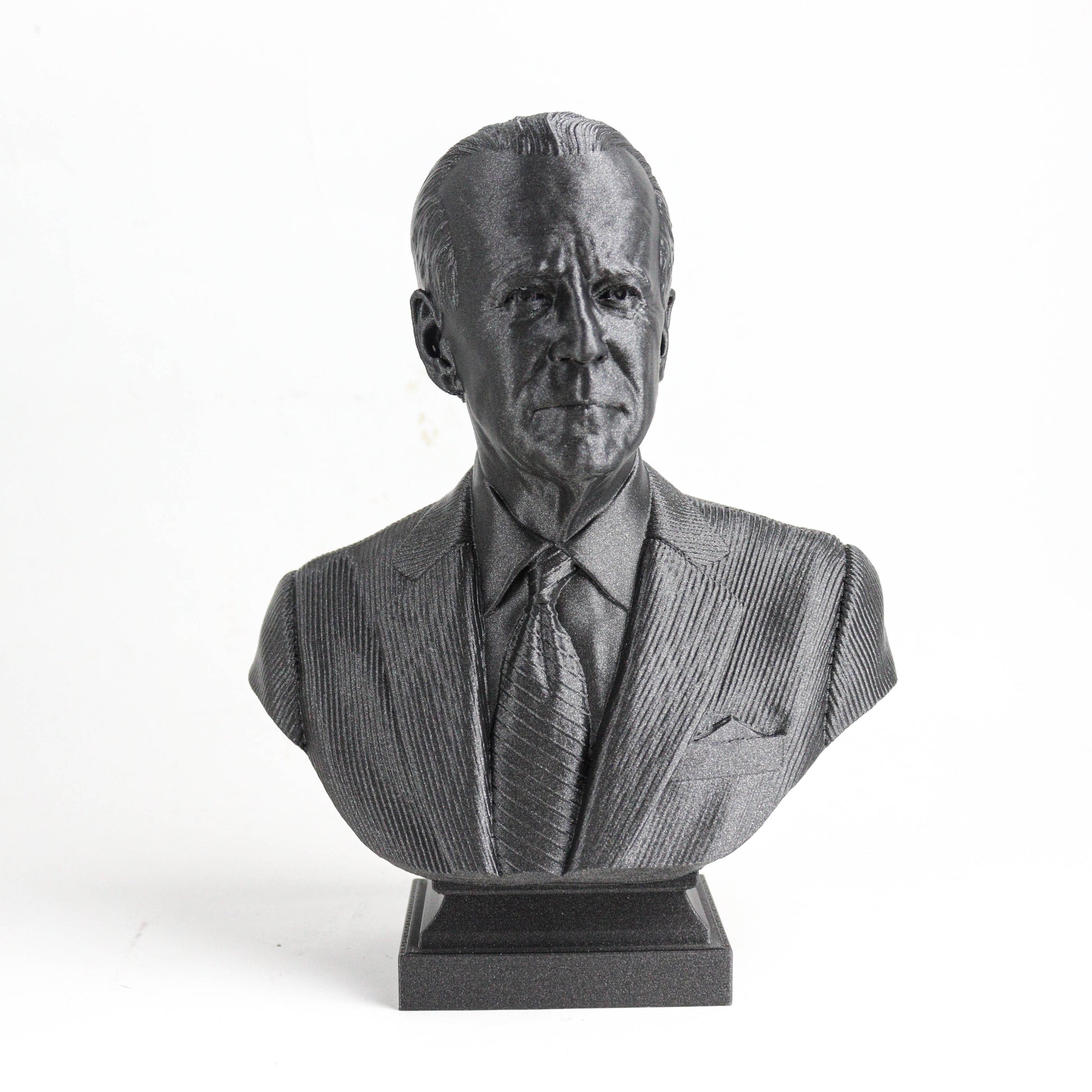 A black and white bust sculpture of a man wearing a suit and tie.