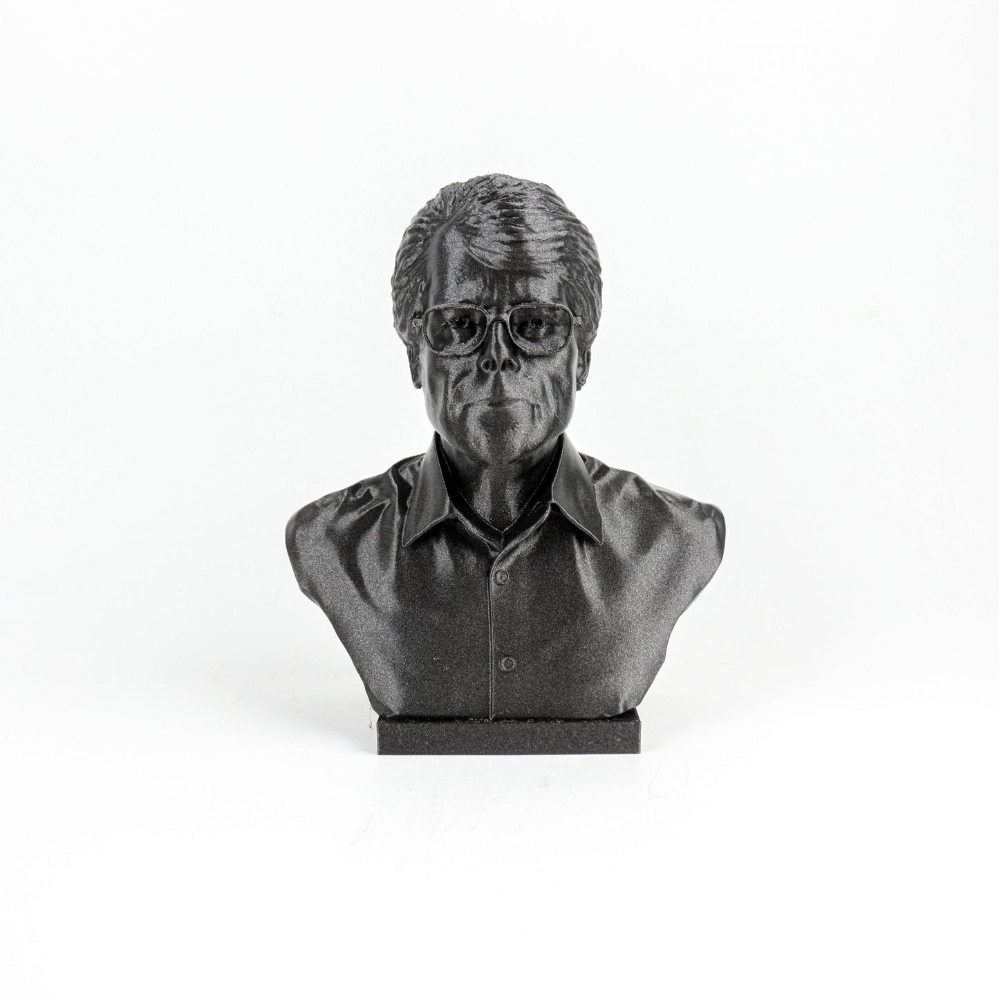 A black and white image of a bust sculpture of a person wearing glasses.