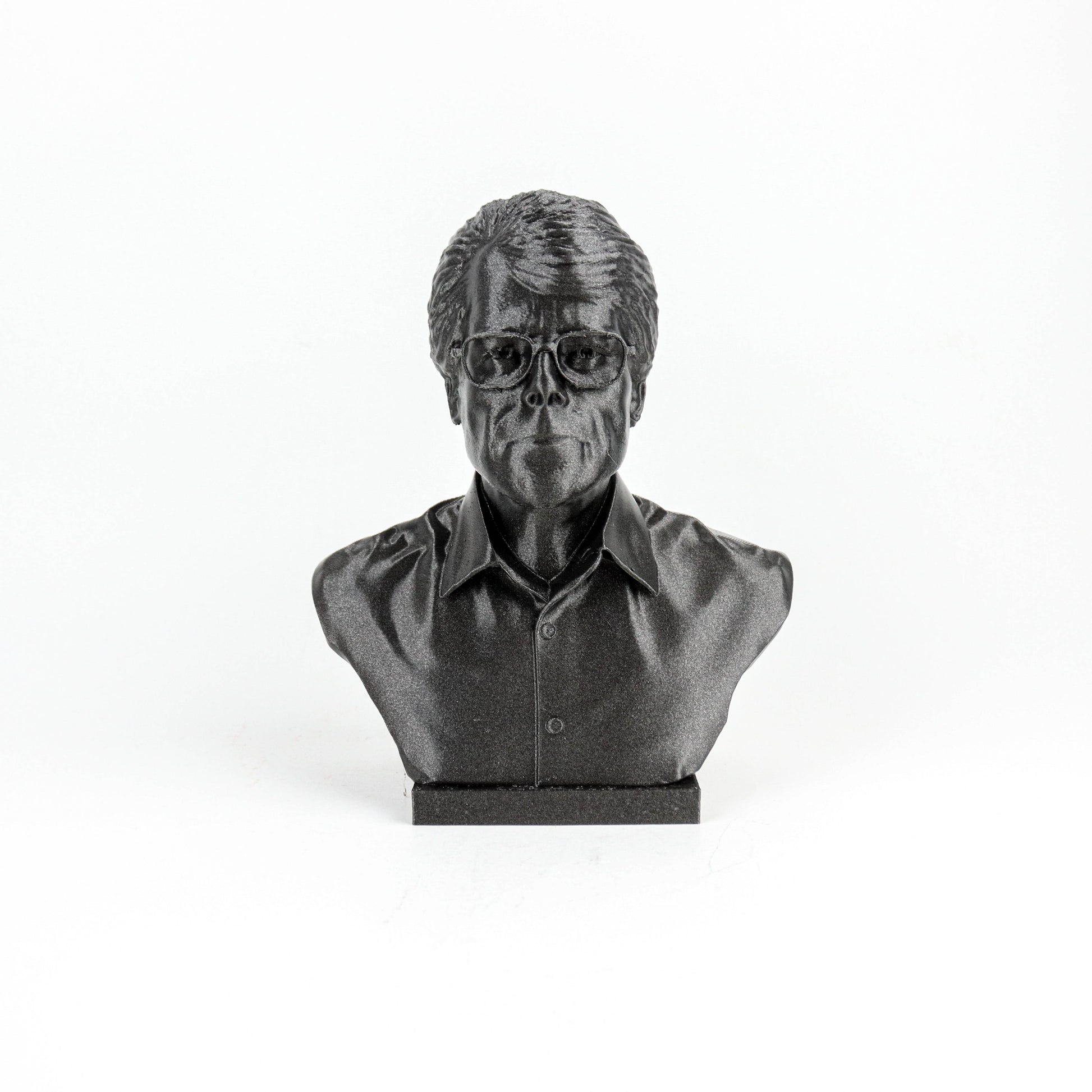 A black and white image of a bust sculpture of a person wearing glasses.