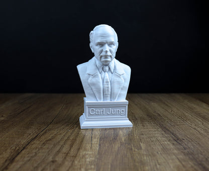 A white bust of a man wearing a suit and tie, with the name "Carl Jung" engraved on a pedestal below it.
