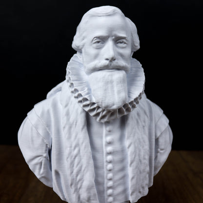 A white bust sculpture of a man with a beard and ruffled collar, set against a dark background.