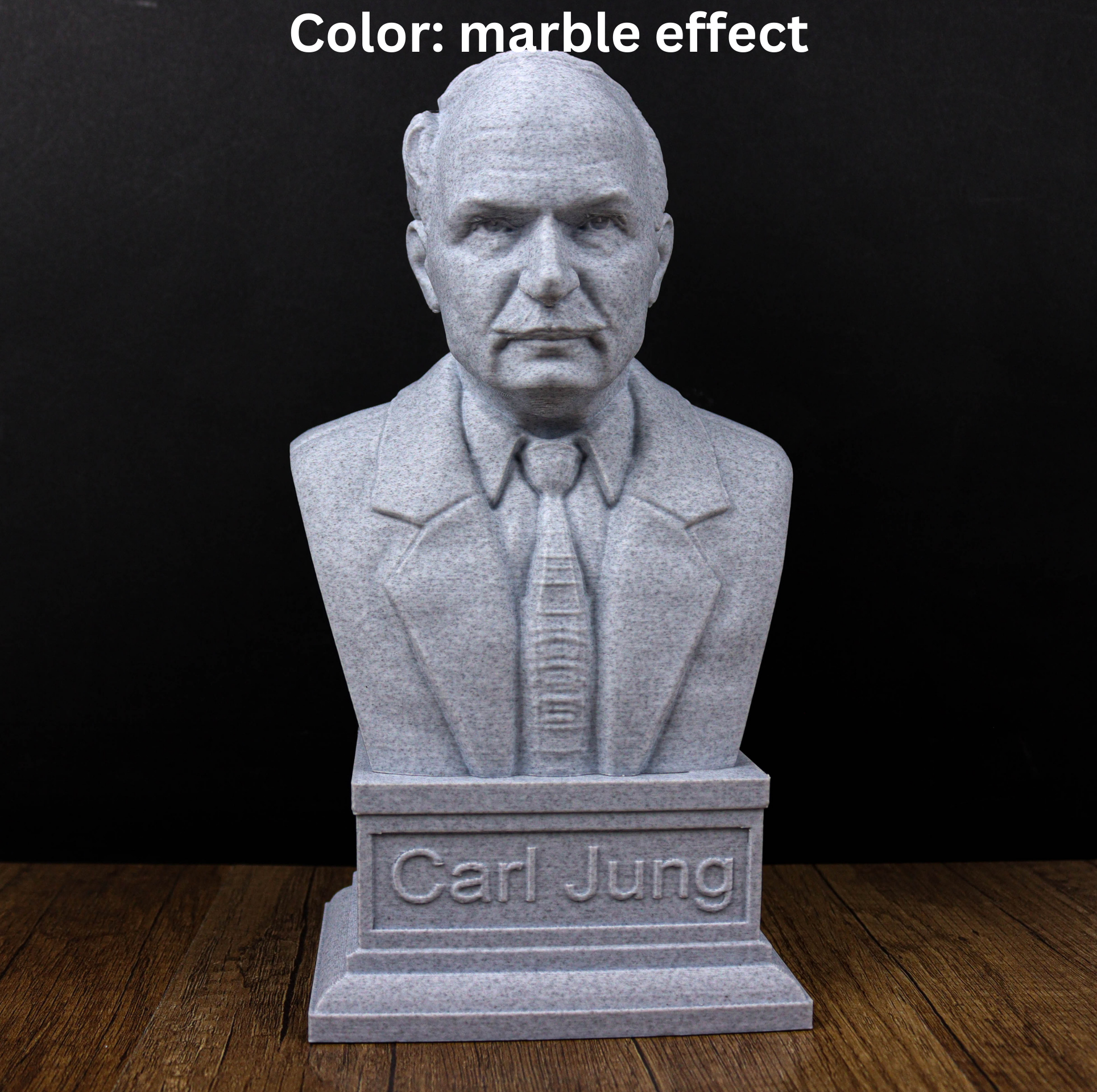 A gray stone bust of a man wearing a suit and tie, with the name "Carl Jung" engraved below the bust.