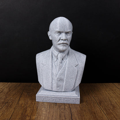 A bust of Vladimir Lenin, a prominent Russian political leader, is displayed on a wooden surface against a black background.