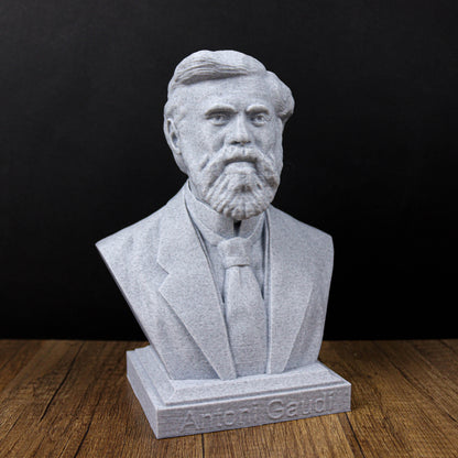 A bust of a bearded man wearing a suit and tie, sitting on a wooden surface.