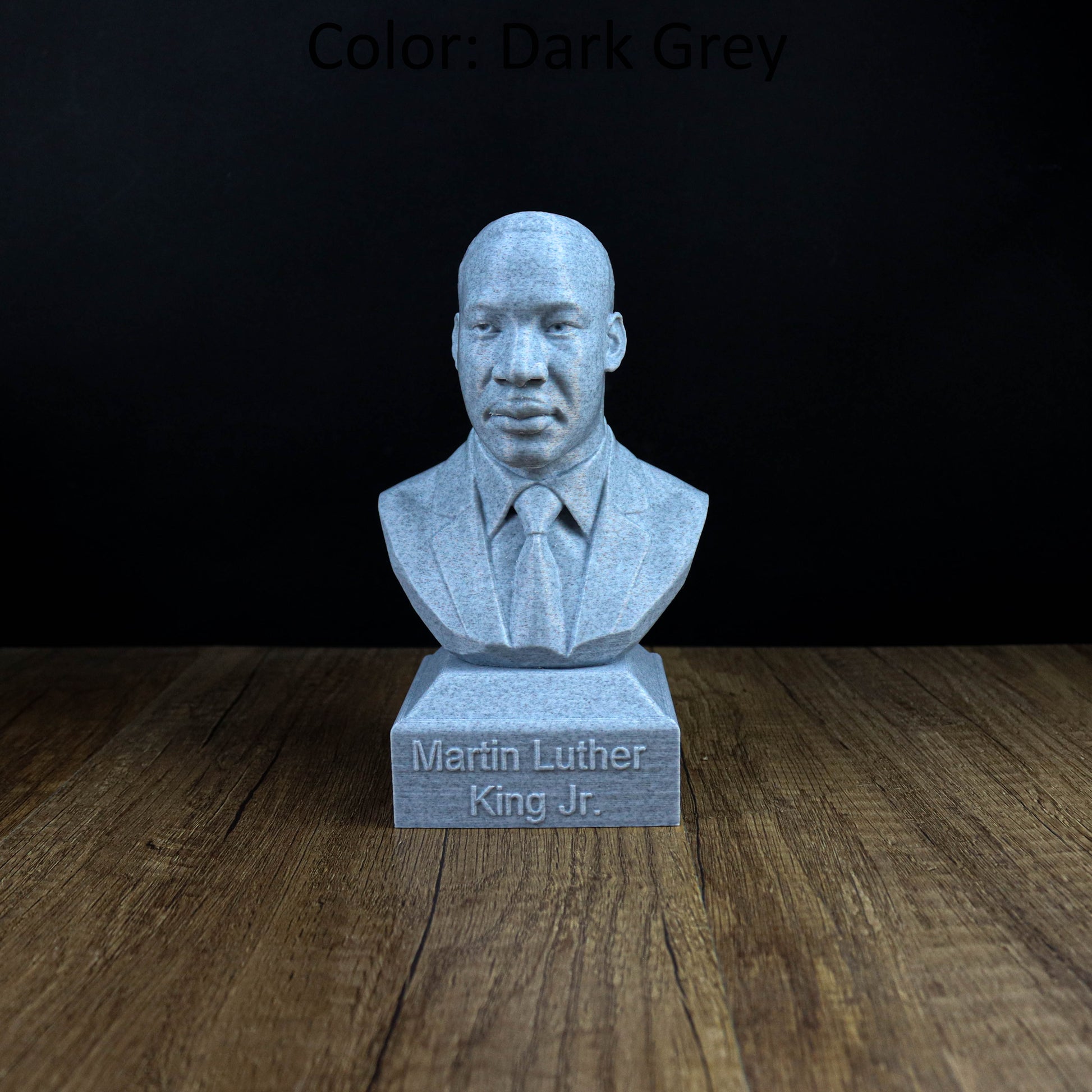 A bust of Martin Luther King Jr. is displayed on a wooden surface, with the text "Martin Luther King Jr." engraved below it.