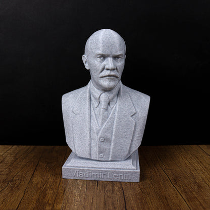 A bust of Vladimir Lenin, a prominent Russian political leader, is displayed on a wooden surface against a black background.