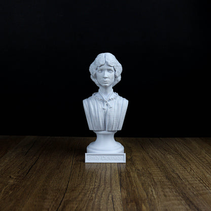 A white bust of a person, likely a historical figure, is displayed on a wooden surface against a black background.