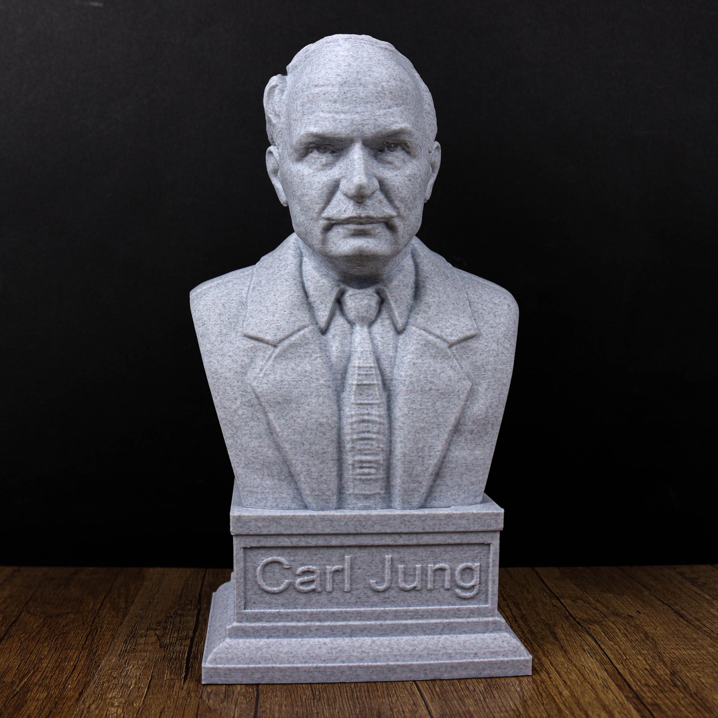 A bust of a man wearing a suit and tie, with the name "Carl Jung" engraved on the base.