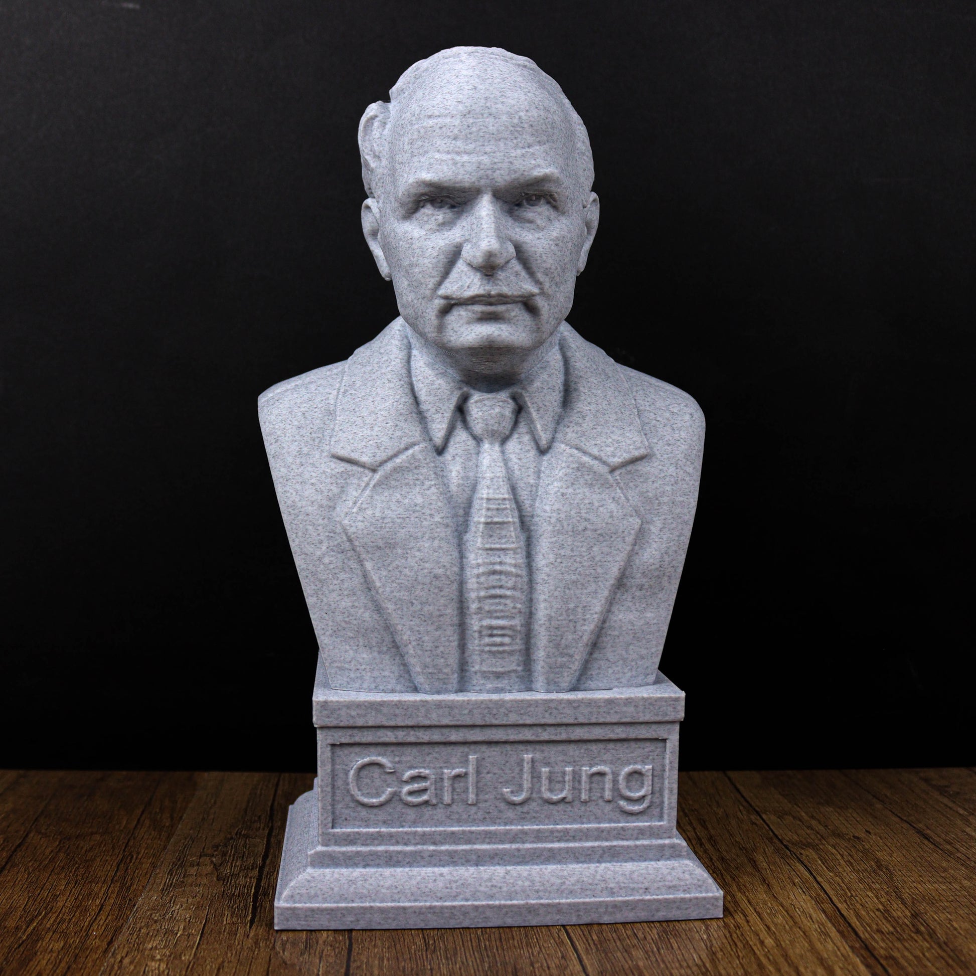 A bust of a man wearing a suit and tie, with the name "Carl Jung" engraved on the base.