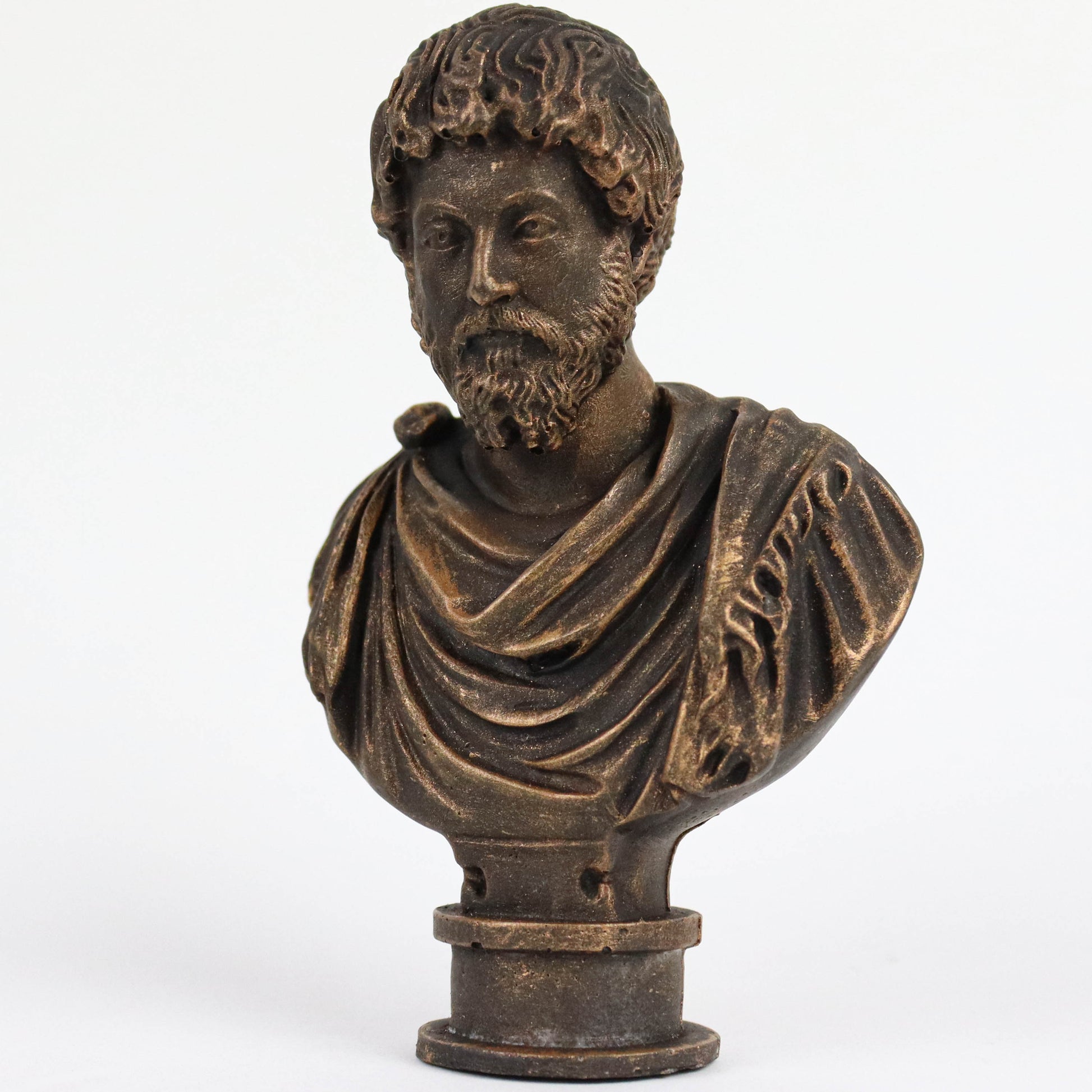A bronze bust of a bearded man wearing a draped robe, likely depicting a historical figure or deity.