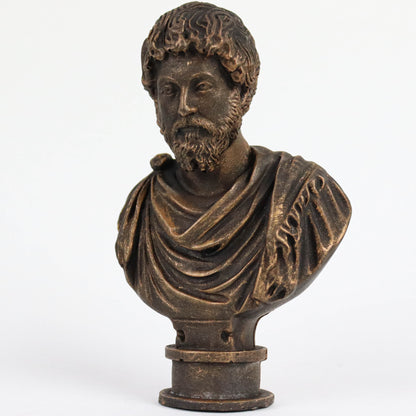 A bronze bust of a bearded man wearing a draped robe, likely depicting a historical figure or deity.