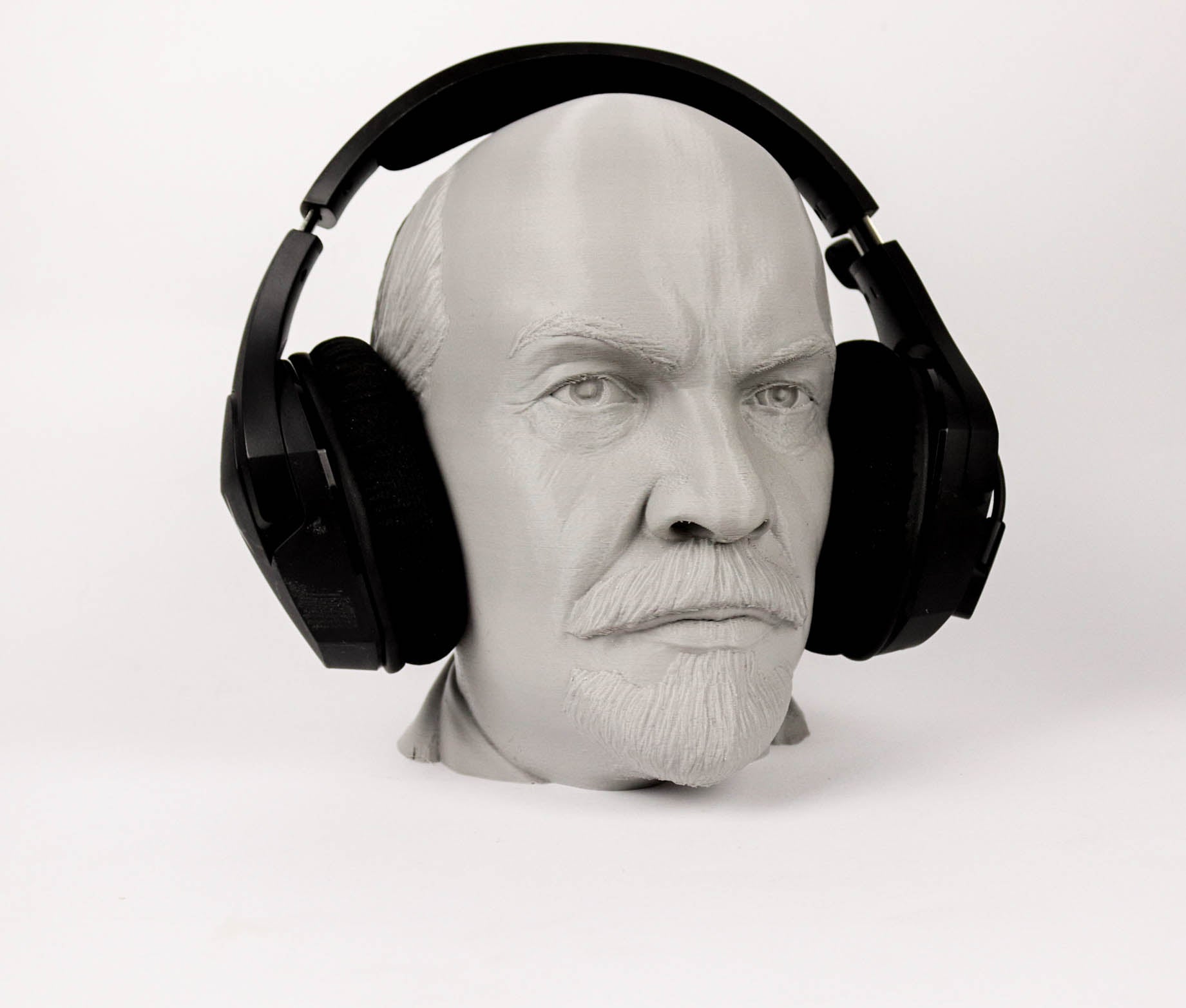 A 3D printed head wearing black headphones.
