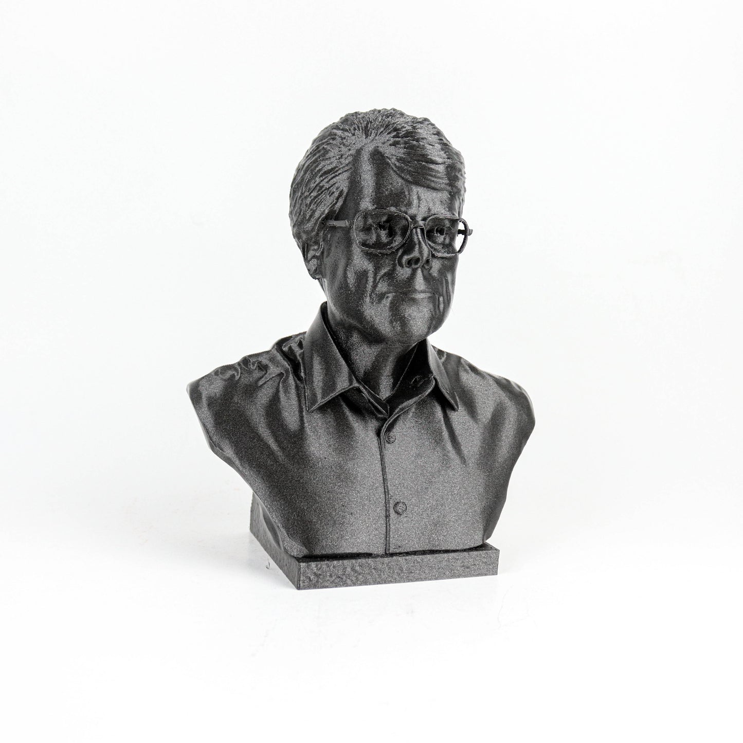 A black and white image of a bust sculpture depicting a man wearing glasses.
