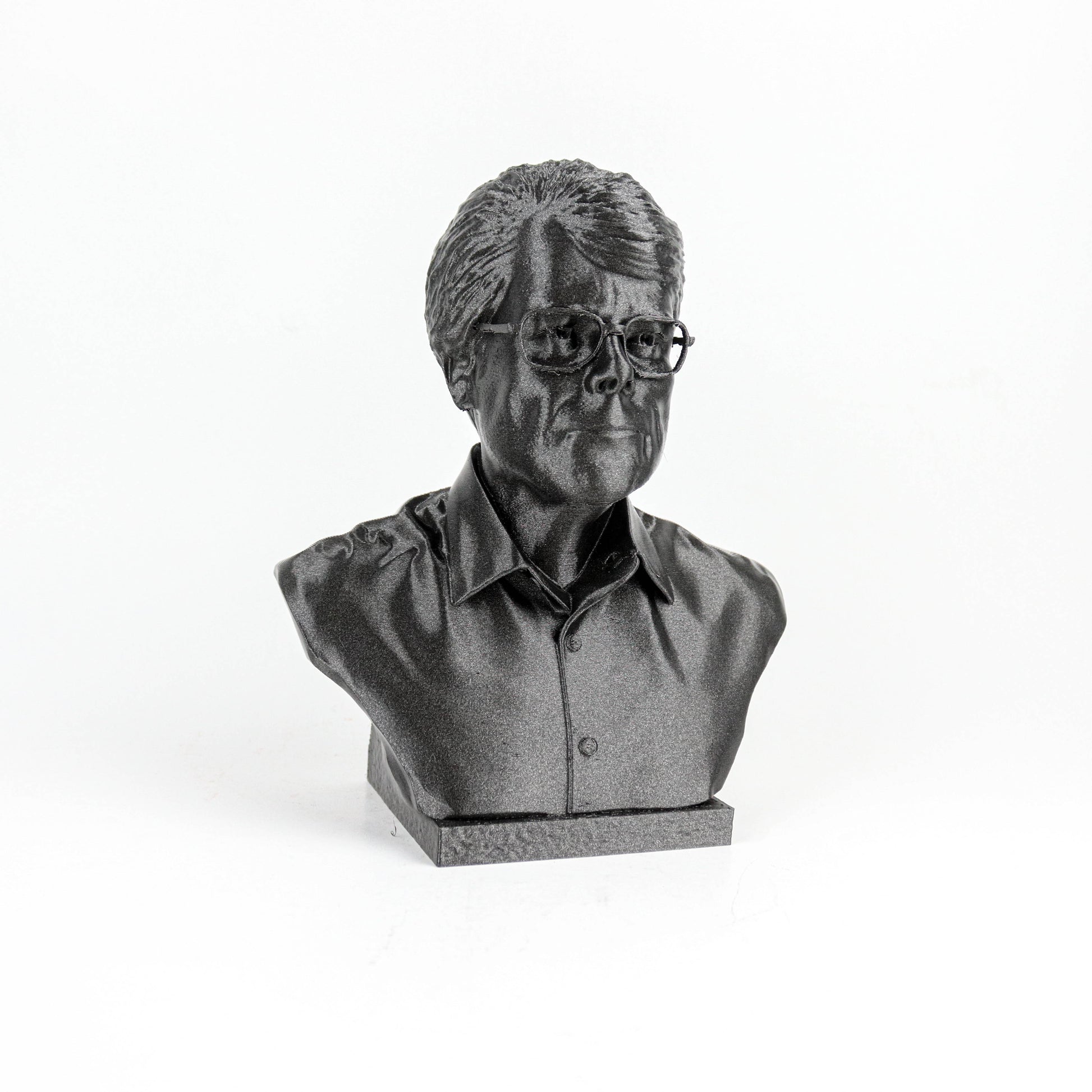 A black and white image of a bust sculpture depicting a man wearing glasses.