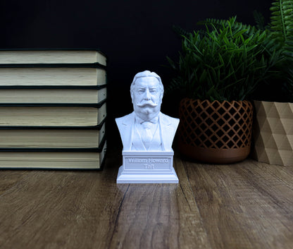A bust of a man is displayed on a wooden surface, surrounded by a stack of books, a potted plant, and a small statue.