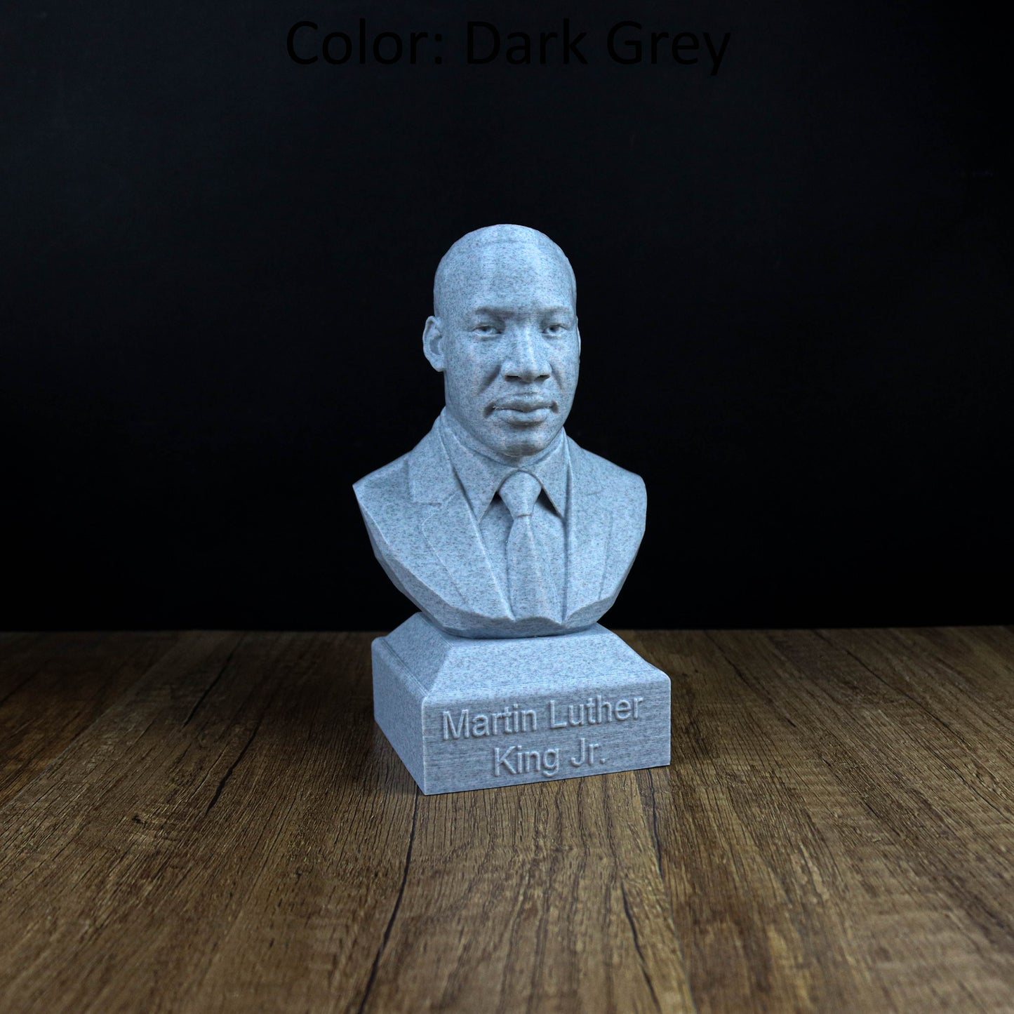 A bust of Martin Luther King Jr. is displayed on a wooden surface, with the text "Martin Luther King Jr." engraved below it.