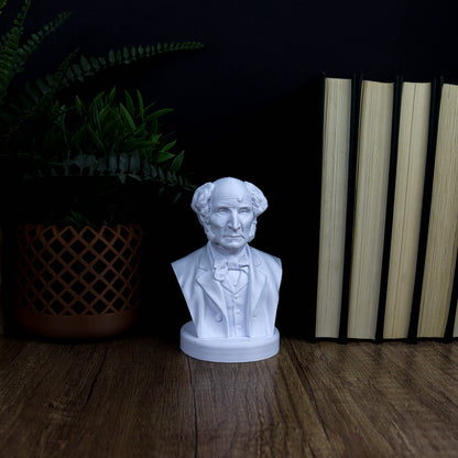 A white bust of a man is displayed on a wooden surface, surrounded by a potted plant and a stack of books.